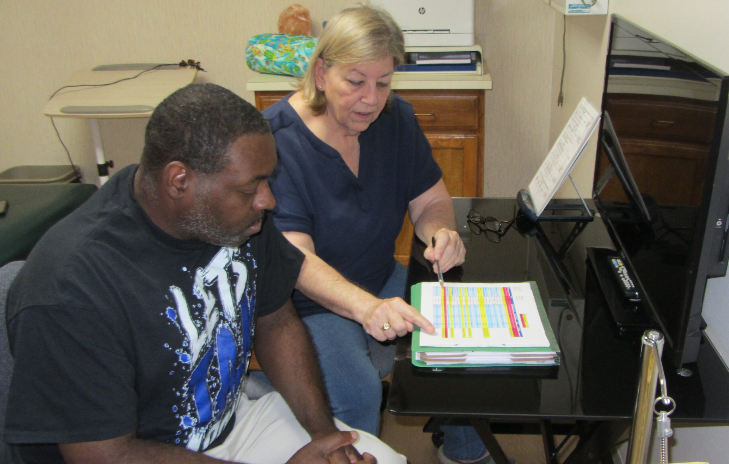 Dr. Pearce going over a bloodwork report with a patient